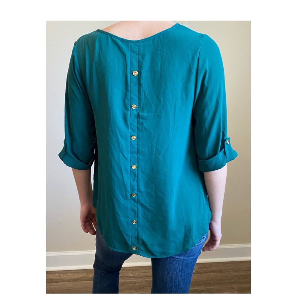 This beautiful Silk turquoise top in a size medium. Hung to dry and gently worn